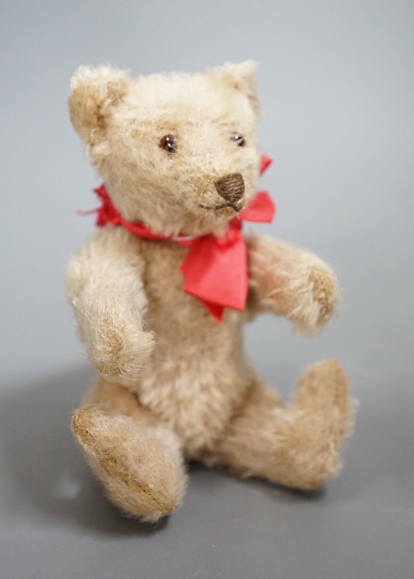 A small Steiff bear, with button in ear, c.1920, 14cm high